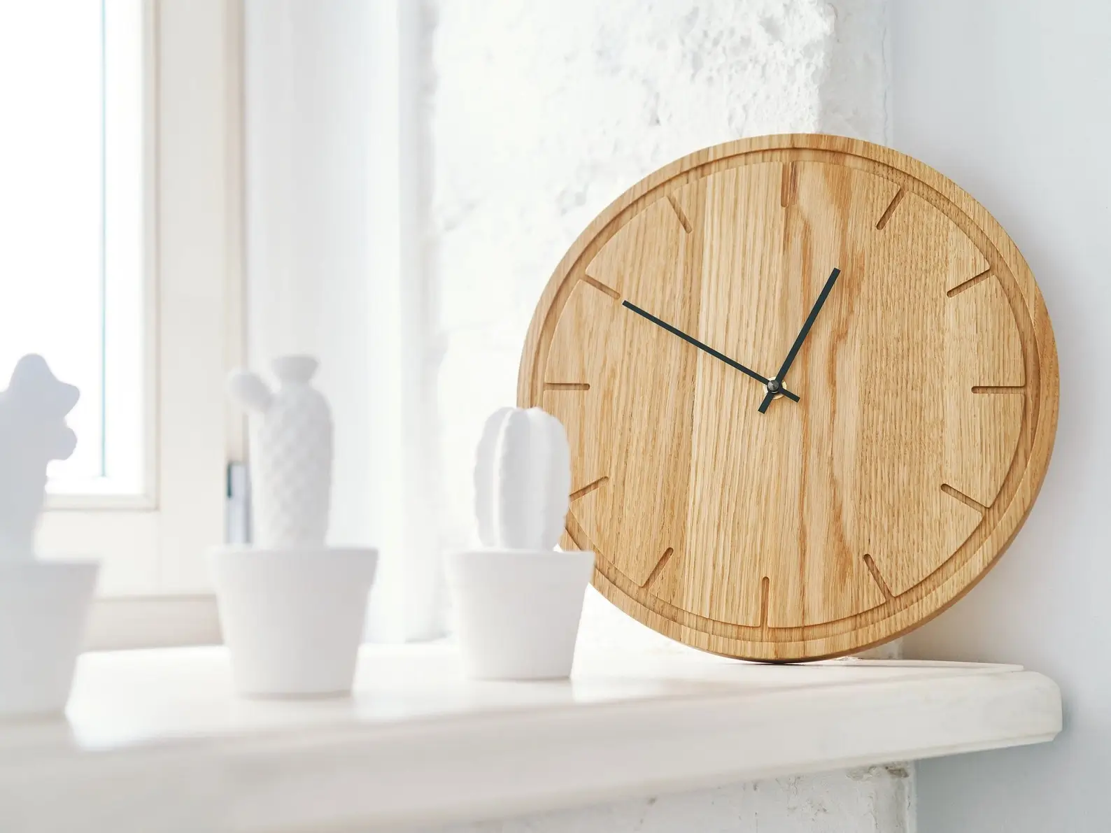 A wall clock made from natural oak wood.